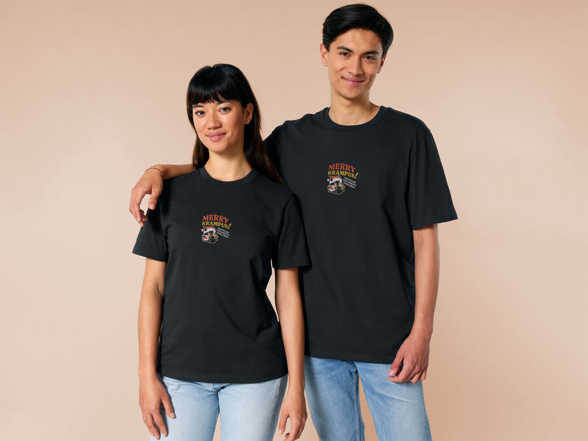 A black crew neck short sleeve tshirt, with an embroidered chibi krampus christmas demon holdign a sack and the quote Mery Krampus! Muffled Children's screams