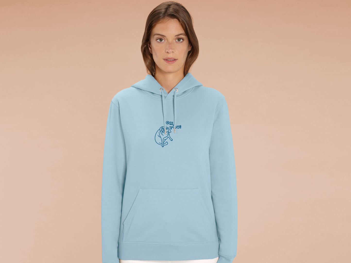 Man wearing a blue long sleeve fleece hoodie, with an embroidered blue thread design of cute meme dog with cheeky expression and big eyes, with the text Oh You!