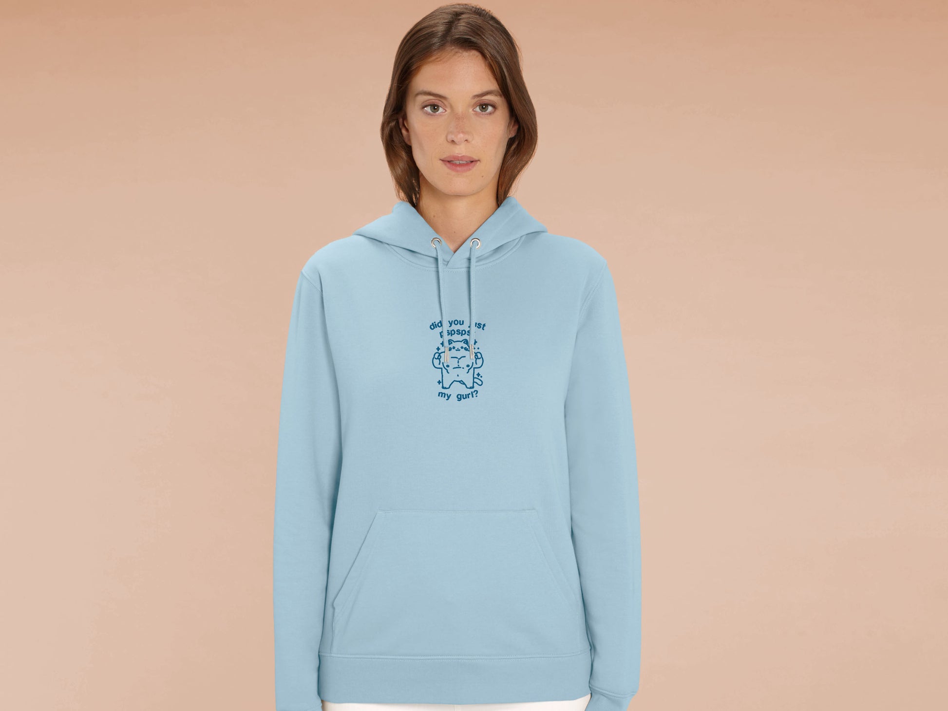 A woman wearing a long sleeved blue fleece hoodie with a blue embroidered design with a cute muscular chibi cat design and the text did you just pspspst my gurl?