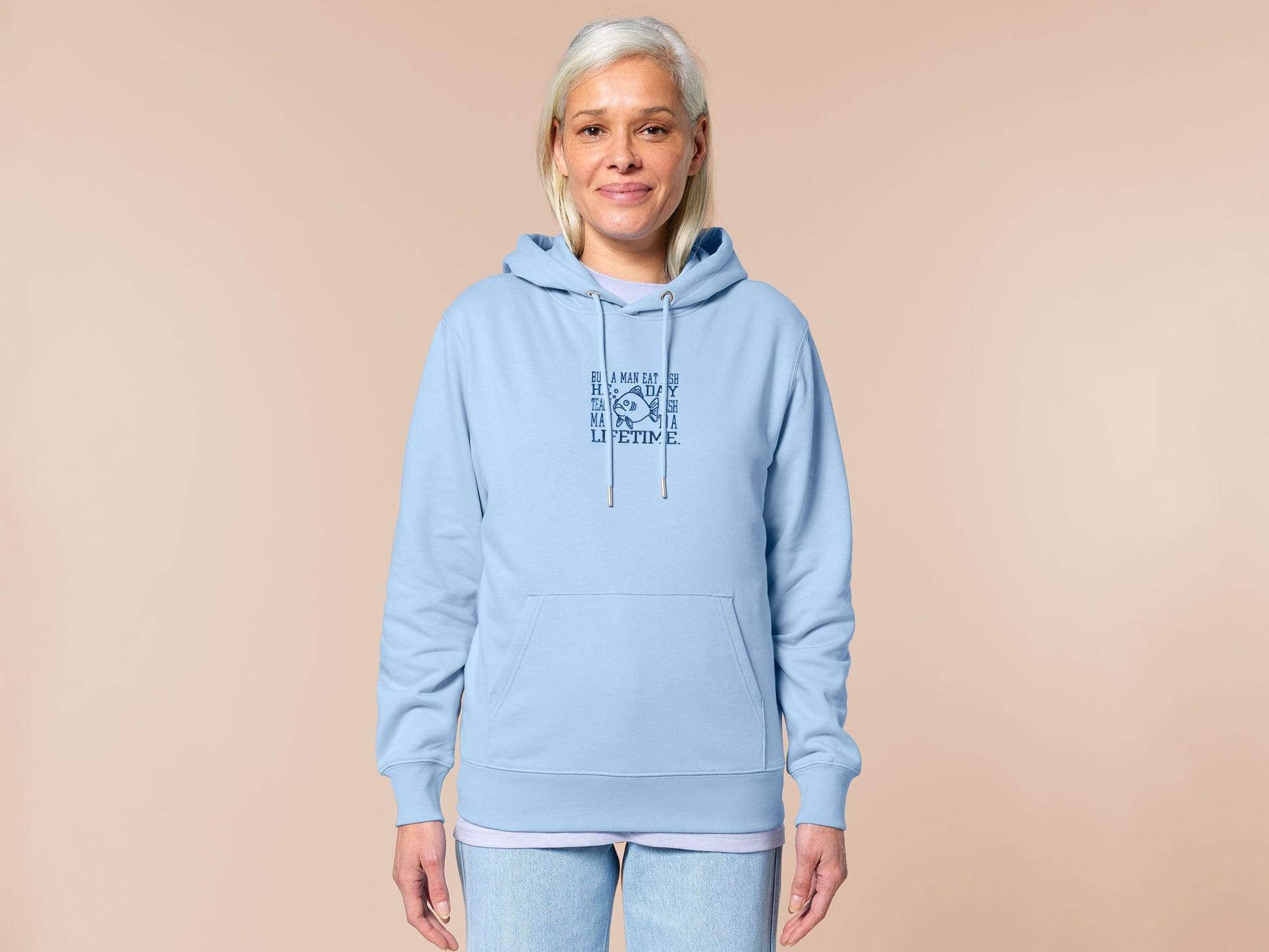 An embroidered blue hoodie design of a funny cartoon fish and the text quote buy a man eat fish he day teach fish man to a lifetime.