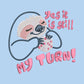 A blue t-shirt with an embroidered design of a cute chibi sloth holiding a board game dice surrounded by the funny quote Yes it is still my turn!