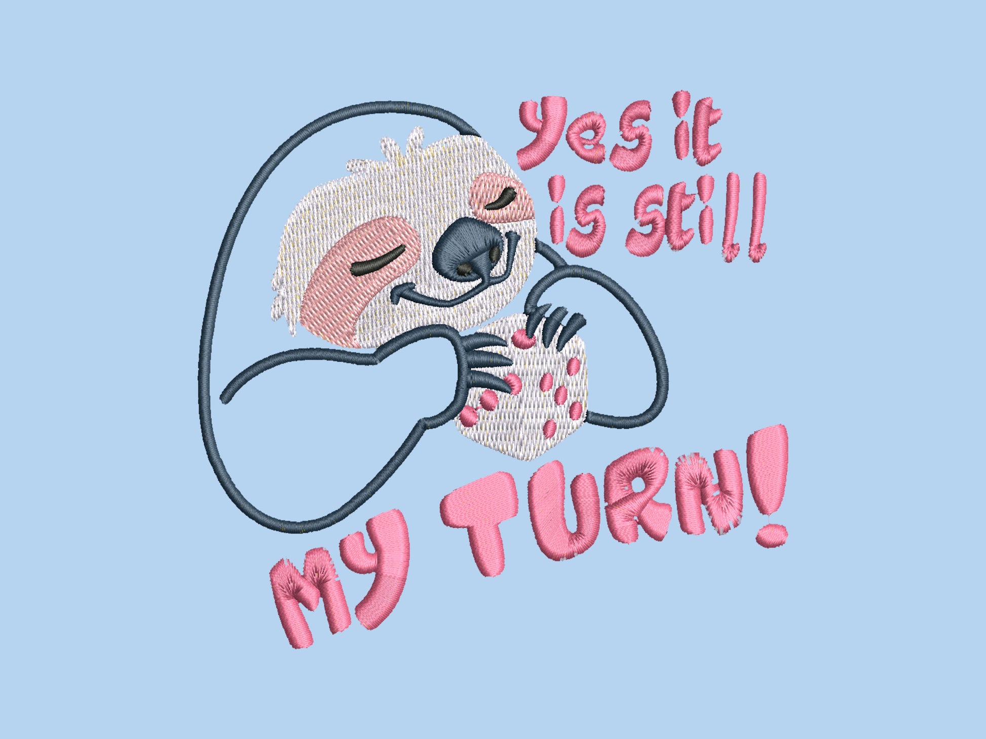 A blue t-shirt with an embroidered design of a cute chibi sloth holiding a board game dice surrounded by the funny quote Yes it is still my turn!