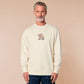 A cream crew neck long sleeve sweater, with an embroidered design of a cute shiba inu dog looking stressed surrounded by the quote Let Me Just Overthink This
