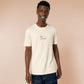 A cream crew neck short sleeve t-shirt, with an embroidered brown thread design of a cute daschund dog looking concerend surrounded by the quote In This Economy?