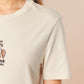 A cream crew neck short sleeve t-shirt, with an embroidered design of a cute shiba inu dog looking stressed surrounded by the quote Let Me Just Overthink This