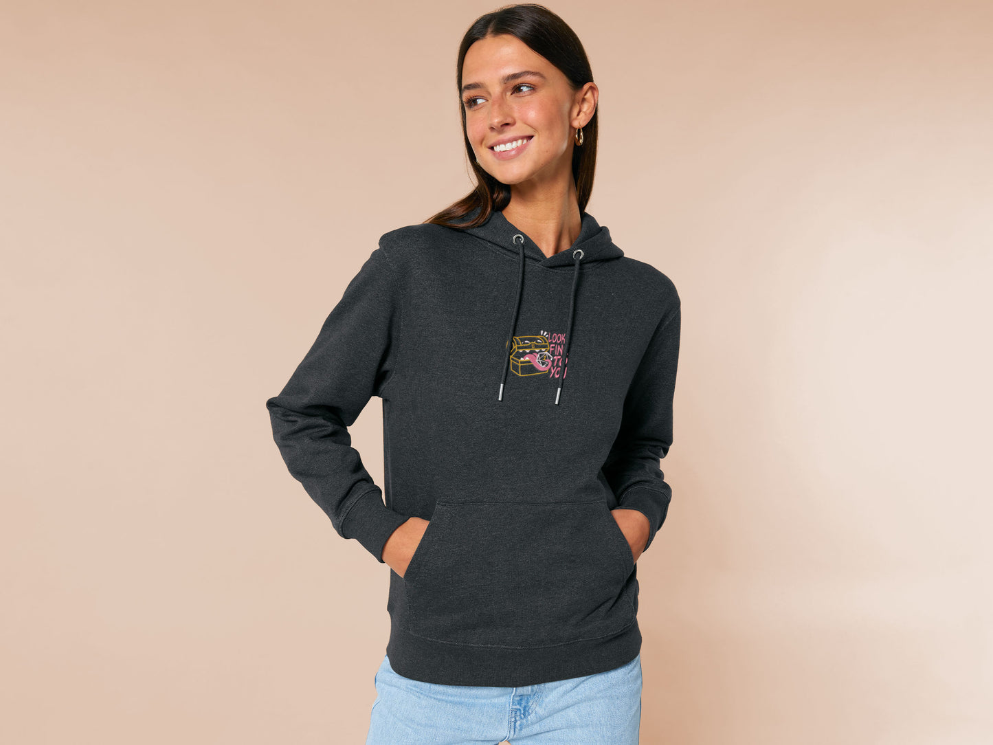 A dark grey crew neck long sleeve hoodie, with an embroidered cute chibi mimic chest holding a D20 dice rolled a one and the quote Looks fine to you.