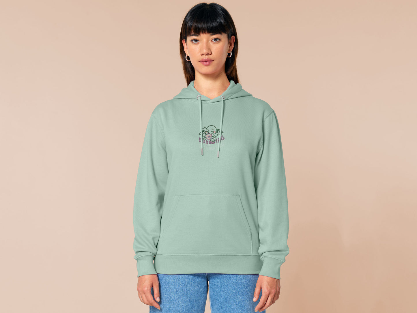 An embroidered green hoodie design of a cute Cthullu with a D20 dice surrounded by the quote This Is How I Roll