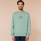 An embroidered green sweater design of a funny cartoon frog with the text a concern.