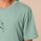 An embroidered green t-shirt design of a funny cartoon frog with the text a concern.
