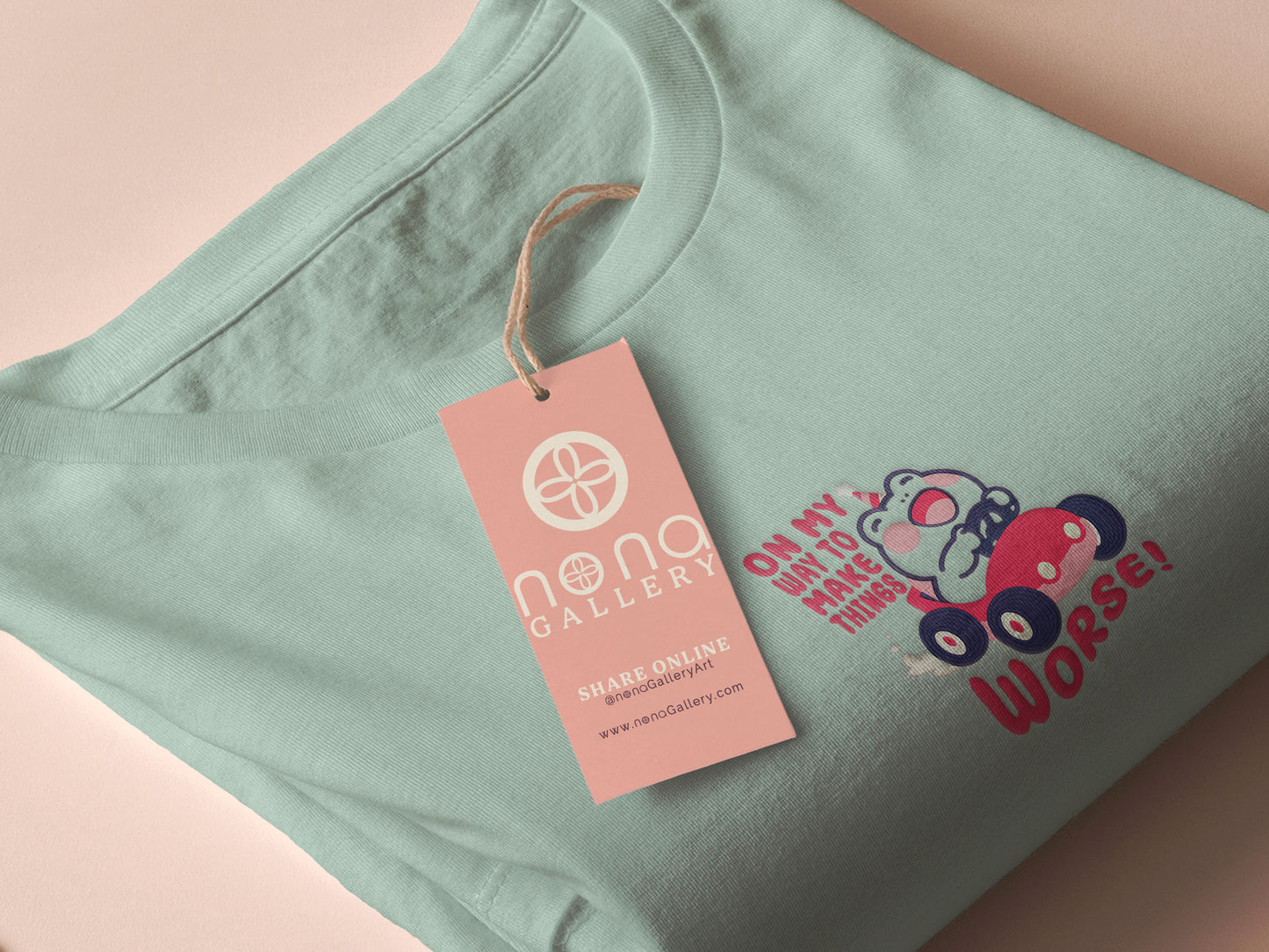 An embroidered green t-shirt design of a cute clown frog wearing a party hat and driving a toy car surrounded by the quote on my way to make things worse!