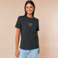 A dark grey crew neck short sleeve t-shirt, with an embroidered chibi mothman and the quote Live Lamp Lurk.