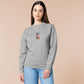 An Embroidered light grey sweater design of a cute chib french snail with the quote sacreblu!