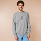 An Embroidered light grey sweater design of a cute chib french snail with the quote sacreblu!