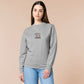 An Embroidered light grey sweater design of a cute chibsuper dog wearing a red cape panicked at a dice with the text rolling one is my superpower