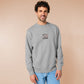 An Embroidered light grey sweater design of a cute chibsuper dog wearing a red cape panicked at a dice with the text rolling one is my superpower