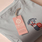 An Embroidered light grey t-shirt design of a cute chib french snail with the quote sacreblu!