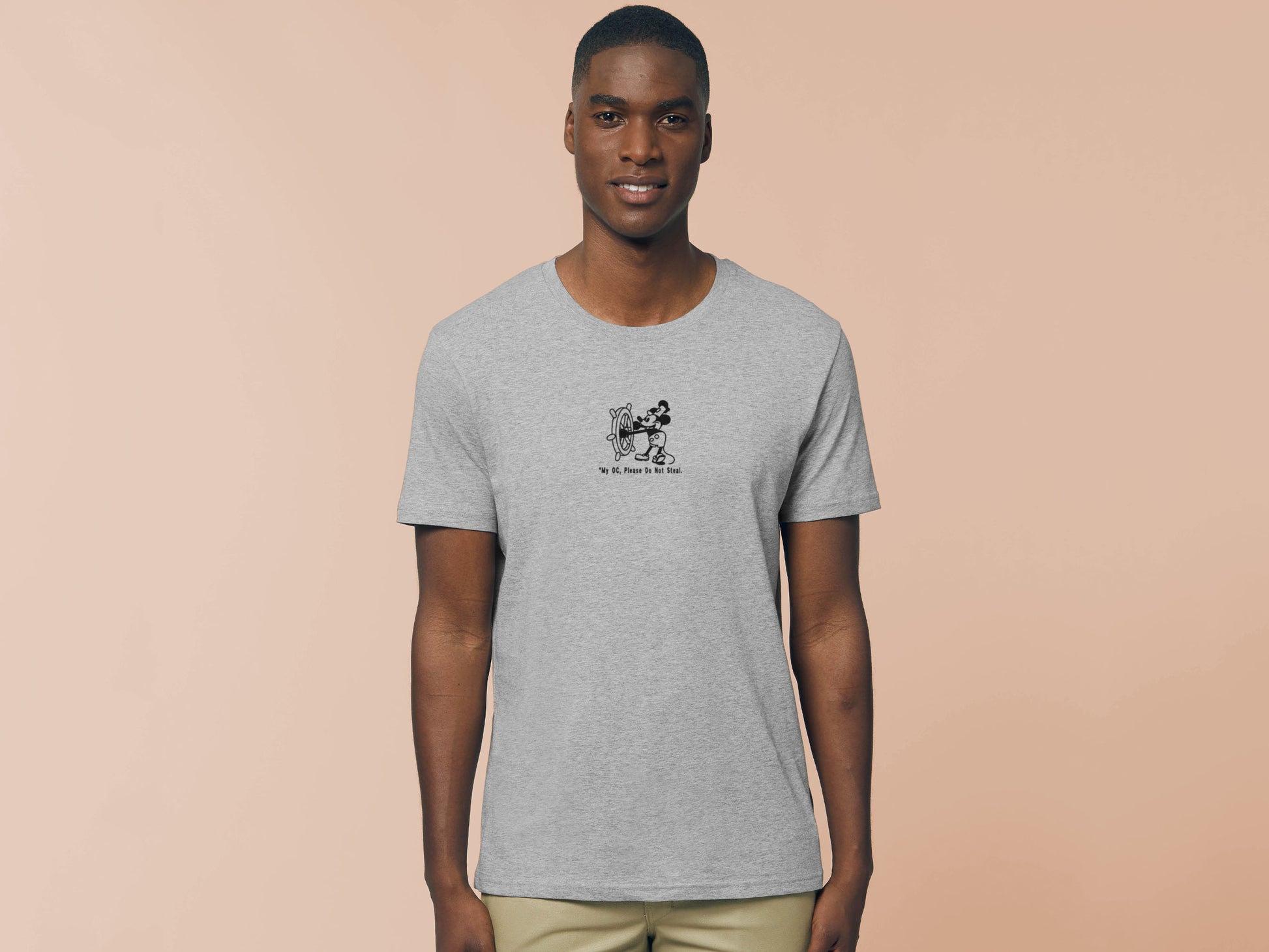 Man in short sleeved grey t-shirt with an Embroidered Black Steamboat Willie Design From Disney's original Mickey Mouse Animation with the text *My OC, Please Don't Steal.
