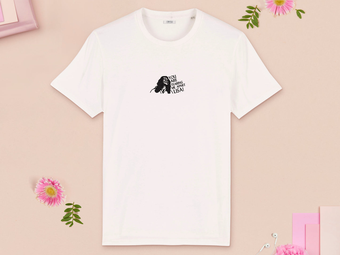 A short sleeved white t-shirt with an embroidered black design of Tommy Wiseau in the movie The Room with the quote You Are Tearing Me Apart Lisa!