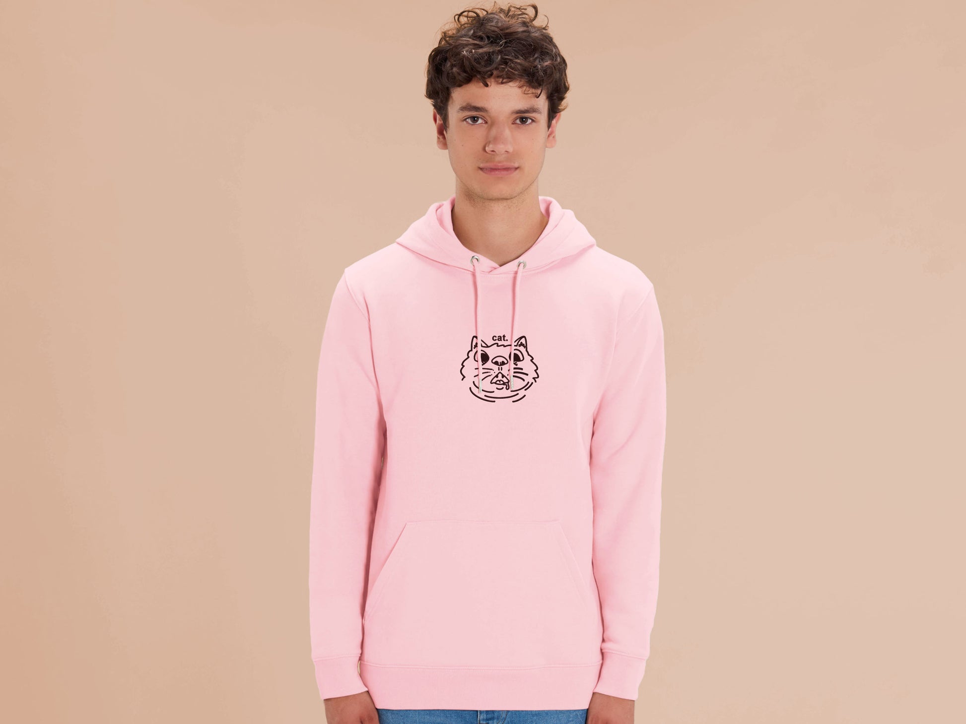 Man wearing a long sleeved pink fleece hoodie with an Embroidered cat design