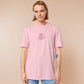 Pink embroidered t-shirt with a cute chibi guinea pig hamster wearing heart-shaped sunglasses and driving a little pink car surrounded by the quote the horrors persist but so do I.