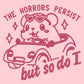 Pink embroidered t-shirt with a cute chibi guinea pig hamster wearing heart-shaped sunglasses and driving a little pink car surrounded by the quote the horrors persist but so do I.