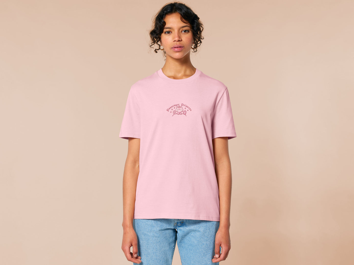 Pink embroidered t-shirt with a cute chibi princess cat wearing a crown and holding a boba tea surrounded by the quote passenger princess