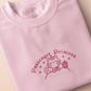 Pink embroidered t-shirt with a cute chibi princess cat wearing a crown and holding a boba tea surrounded by the quote passenger princess