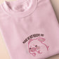 Pink embroidered t-shirt with a cute chibi panicking pig surrounded by the quote please don't perceive me