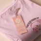 Pink embroidered t-shirt with a cute chibi panicking pig surrounded by the quote please don't perceive me