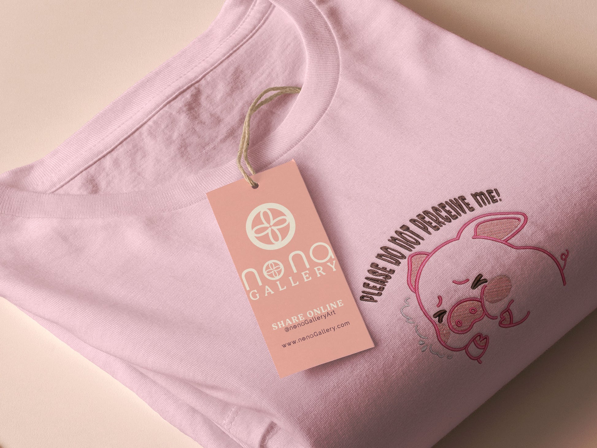 Pink embroidered t-shirt with a cute chibi panicking pig surrounded by the quote please don't perceive me