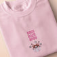 Pink embroidered t-shirt with a cute chibi hamster angry surrounded by the quote smol but angy