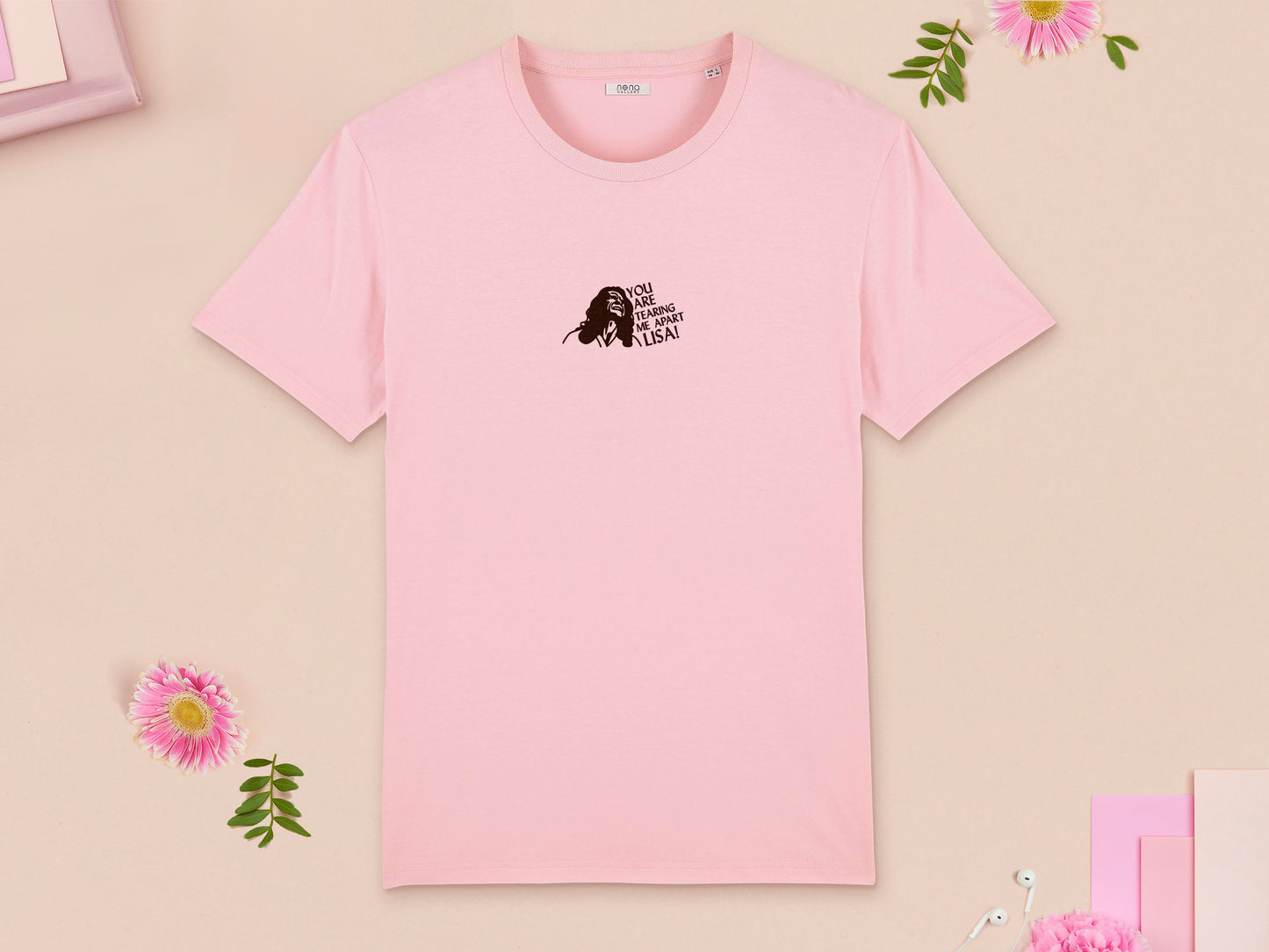 A short sleeved pink t-shirt with an embroidered brown design of Tommy Wiseau in the movie The Room with the quote You Are Tearing Me Apart Lisa!