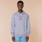 Purple embroidered hoodie with a cute design of a chibi owlbear crying holding a d20 dice that has rolled a one with the quote Crying Is A Free Action