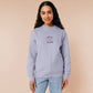 Purple embroidered sweater with a cute design of a chibi owlbear crying holding a d20 dice that has rolled a one with the quote Crying Is A Free Action