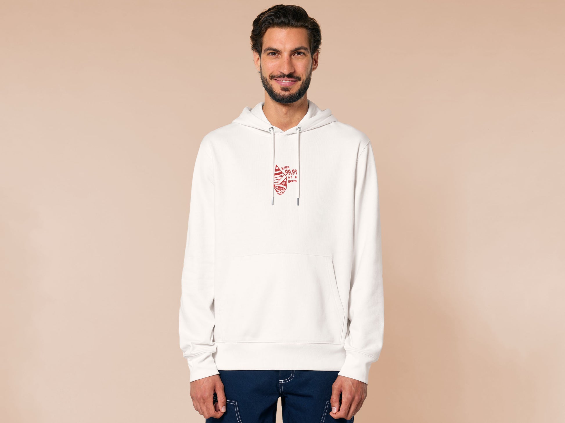 White hoodie with a red embroidered design of the face of Captain Curly from the indie horror game Mouthwashing wearing a party hat and the quote kills 99.9% of al germs!