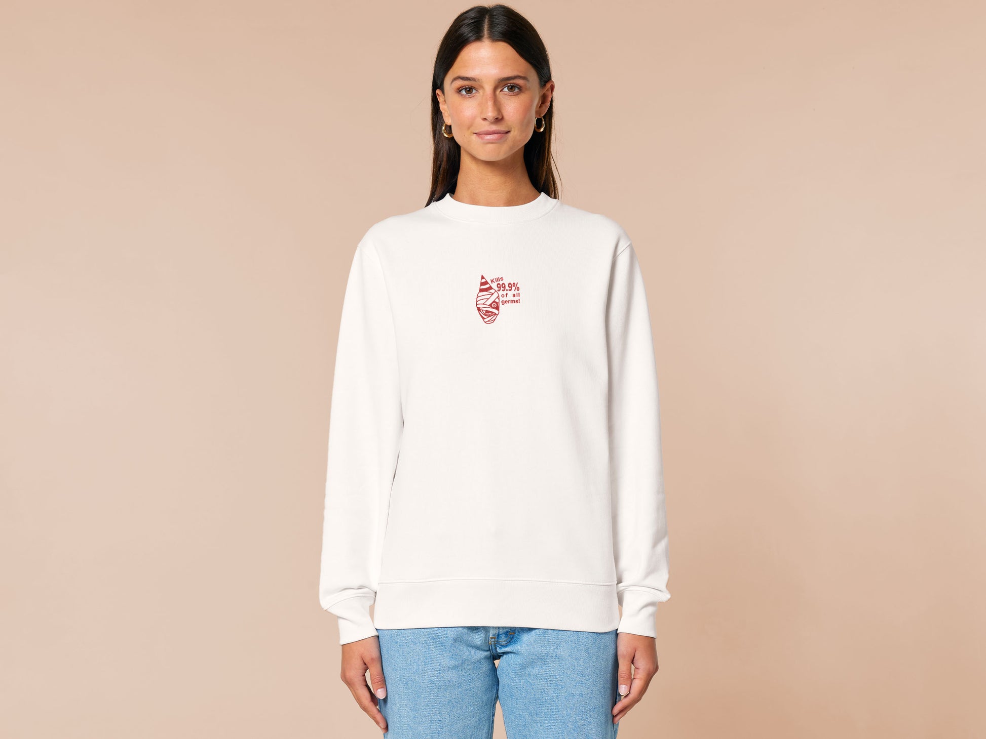 White sweater with a red embroidered design of the face of captain Curly from the indie horror game Mouthwashing wearing a party hat and the quote kills 99.9% of al germs!