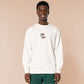 An embroidered white sweater design of a blood drenched meeple holding a knife with text When I Play Board Games I Have No Friends