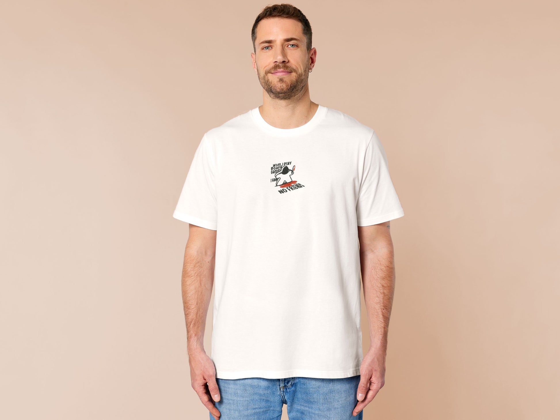 An embroidered white t-shirt design of a blood drenched meeple holding a knife with text When I Play Board Games I Have No Friends