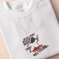 An embroidered white t-shirt design of a blood drenched meeple holding a knife with text When I Play Board Games I Have No Friends