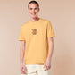 A yellow tshirt with an embroidered design of a cute grumpy red dragon playing a card game with the text why is it not my turn yet?!