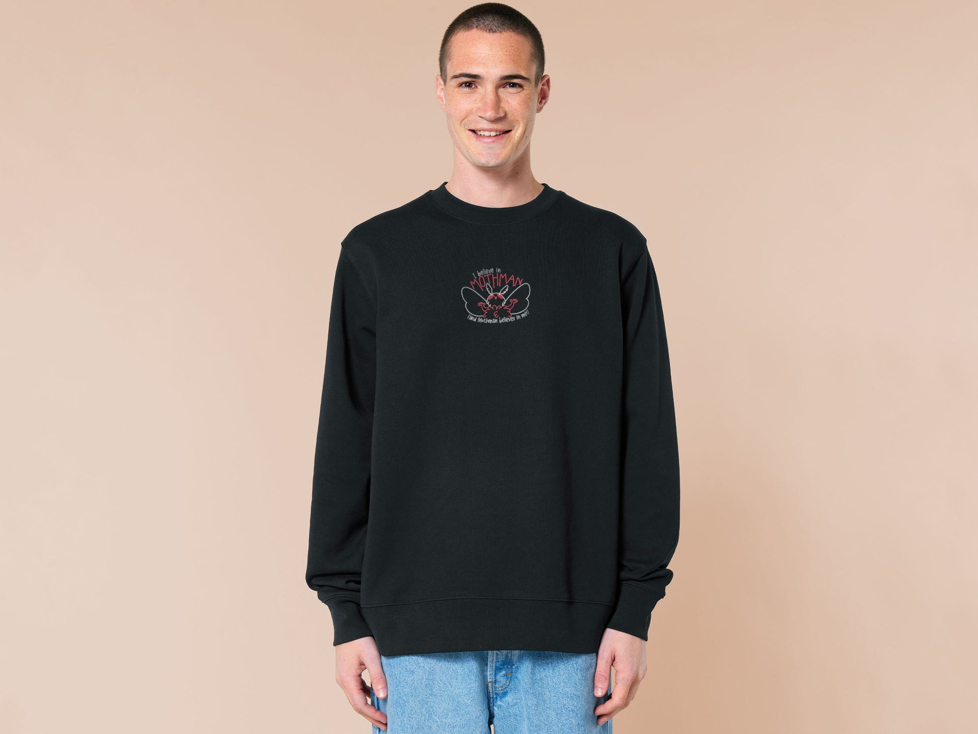 Embroidered black sweater with a cute chibi cryptid design of Mothman with the text I believe in Mothman (and Mothman believes in me!)