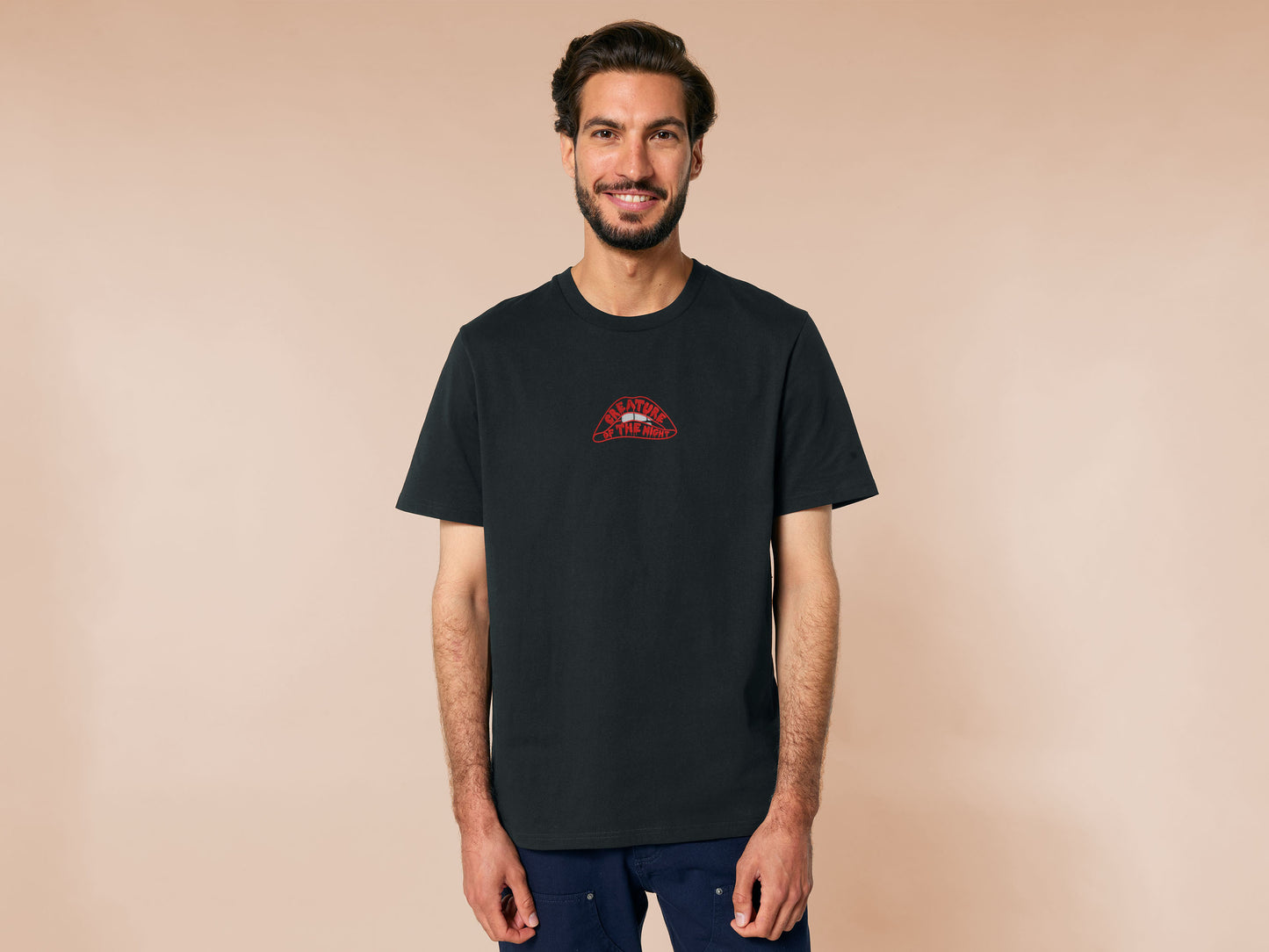 An Embroidered black t-shirt design of the iconicRocky Horror Show Double Feature cult classic sci-fi musical movie's lips with the text within the lips reading Creature of the night 