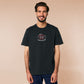 Embroidered black t-shirt with a cute chibi cryptid design of Mothman with the text I believe in Mothman (and Mothman believes in me!)