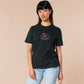 Embroidered black t-shirt with a cute chibi cryptid design of Mothman with the text I believe in Mothman (and Mothman believes in me!)