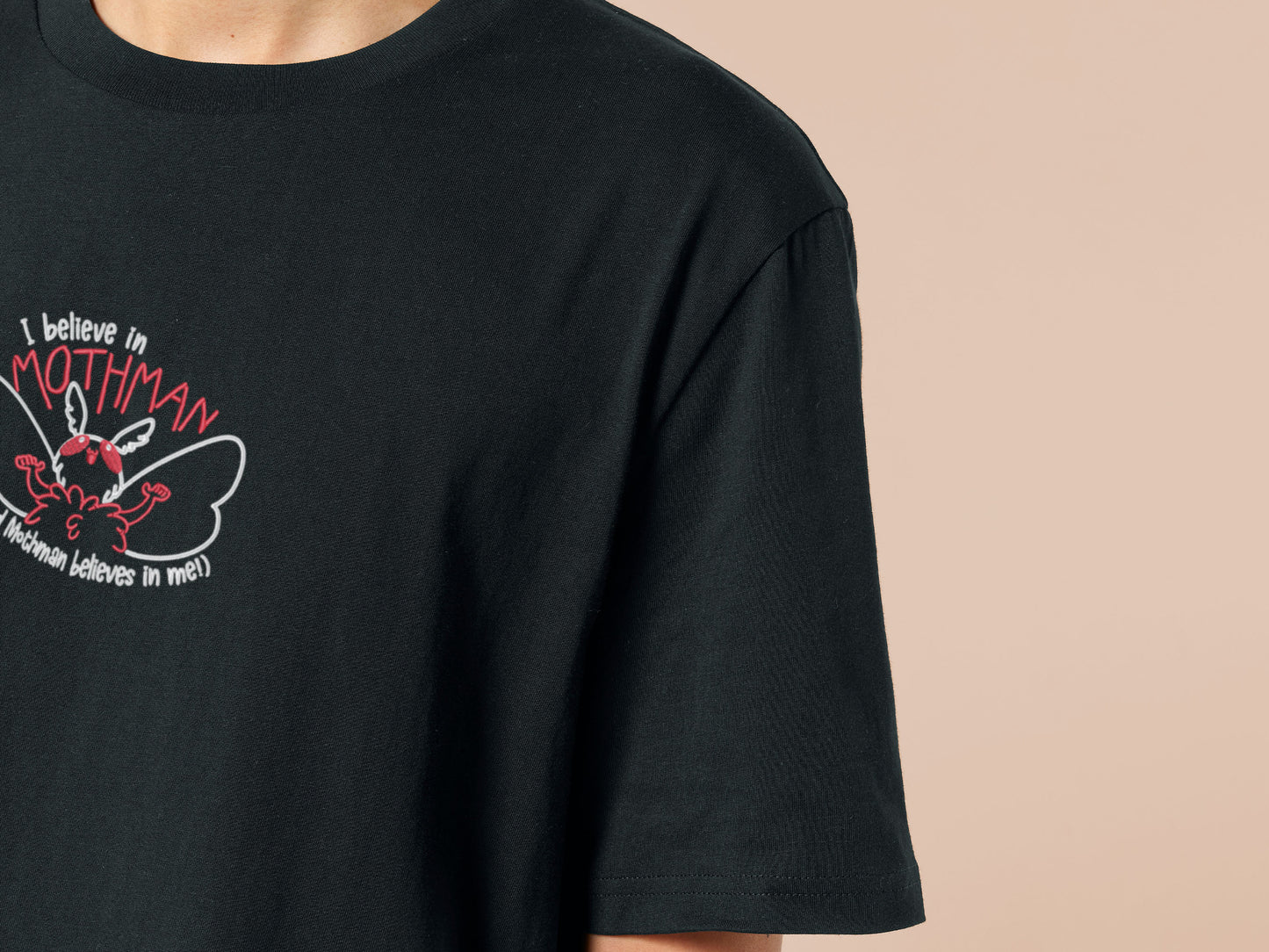 Embroidered black t-shirt with a cute chibi cryptid design of Mothman with the text I believe in Mothman (and Mothman believes in me!)