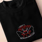 Embroidered black t-shirt with a cute chibi cryptid design of Mothman with the text I believe in Mothman (and Mothman believes in me!)