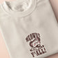 A cream crew neck short sleeve t-shirt, with an embroidered brown thread design of a cute cowboy cat with hat surrounded by the quote meowfy ya'll!