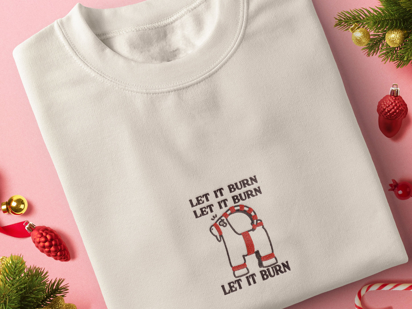 Cream Christmas jumper with an embroidered design of the viral Gavle Straw Goat surrounded by the quote let it burn, let it burn, let it burn.