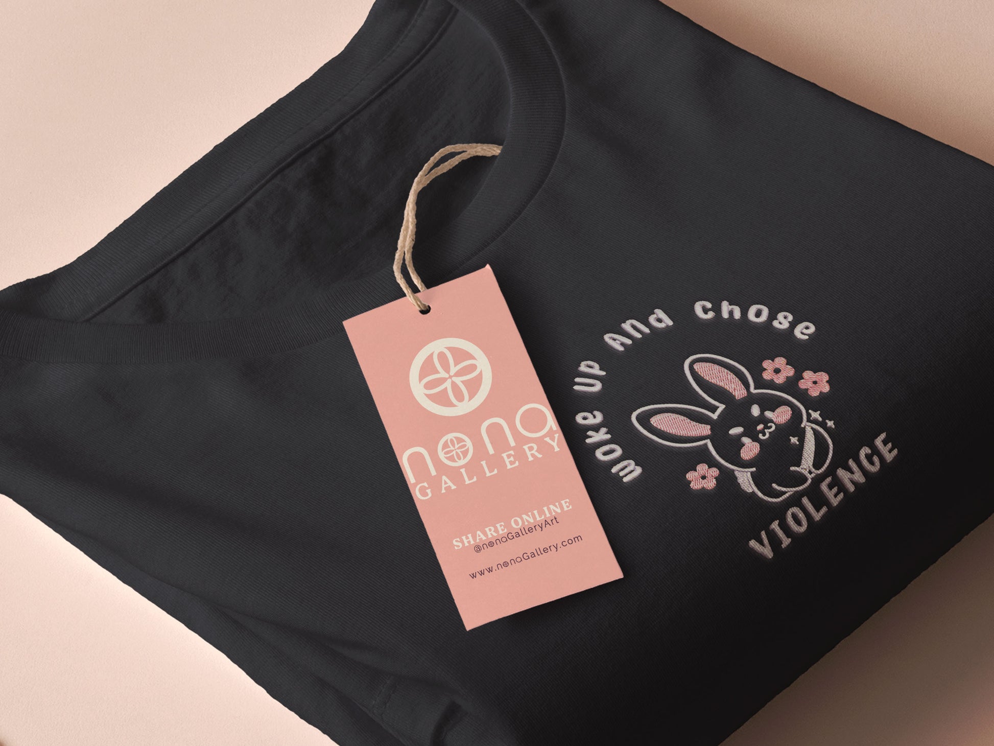 An embroidered dark grey t-shirt with a cute chibi bunny and the text Woke Up And Chose Violence.