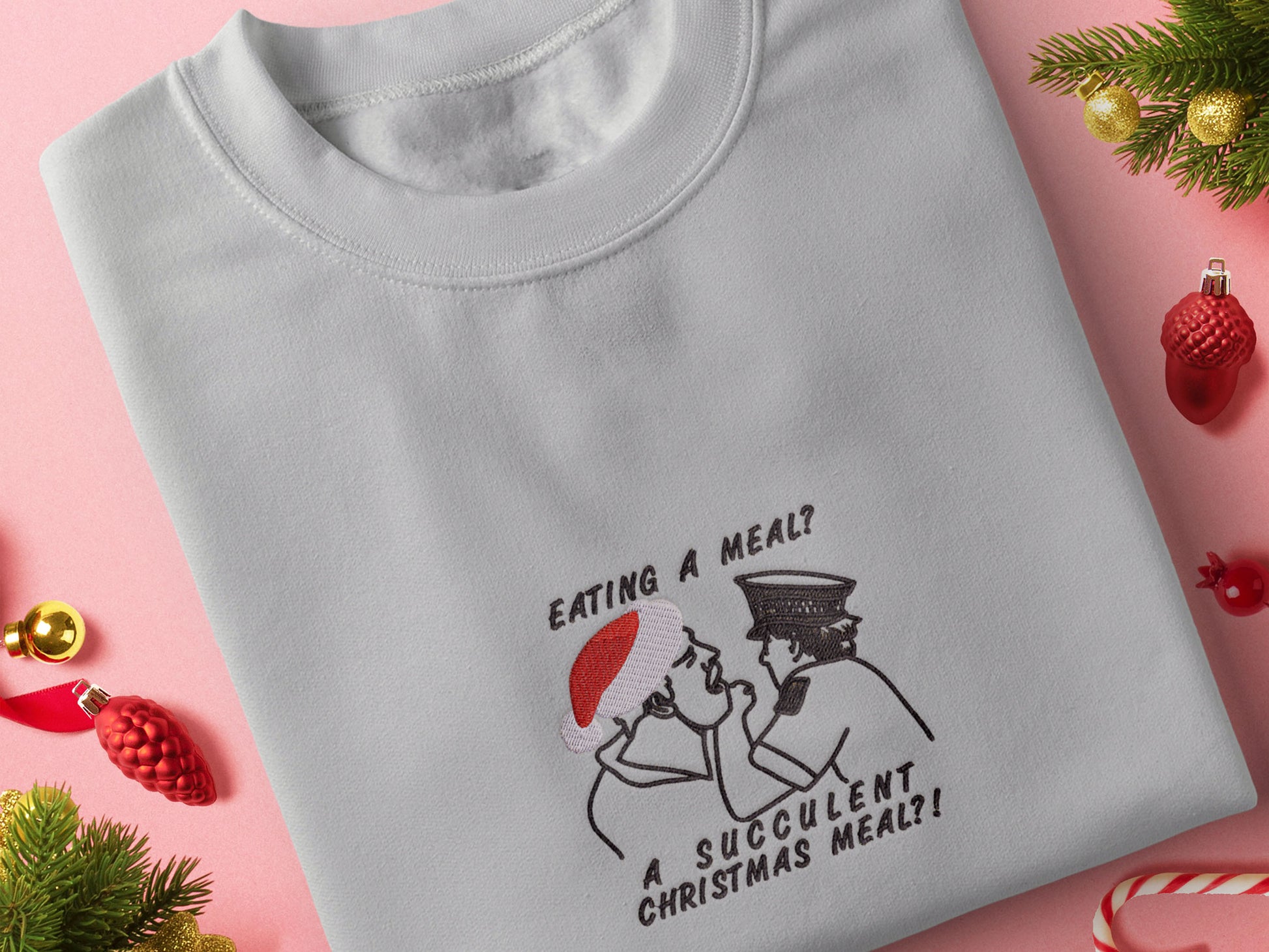 Grey Christmas jumper with an embroidered design of the viral YouTube arrest video Democracy manifest eating a meal a succulent Chinese meal, but instead, it says Christmas Meal and Jack Karlson is wearing a red Christmas hat.